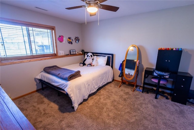 carpeted bedroom with visible vents, baseboards, and ceiling fan