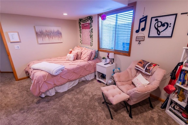 carpeted bedroom featuring baseboards