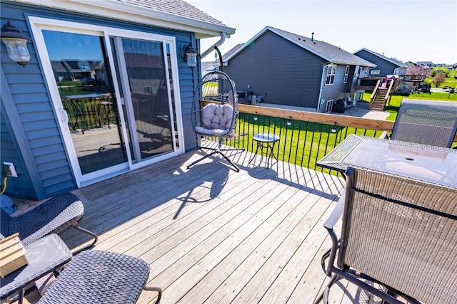wooden terrace featuring a yard and a residential view
