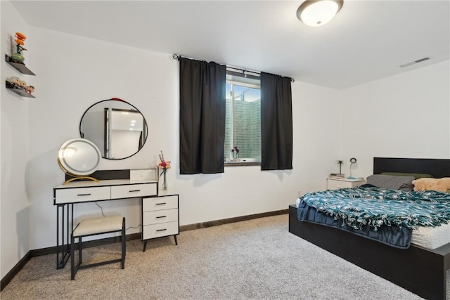carpeted bedroom with baseboards and visible vents