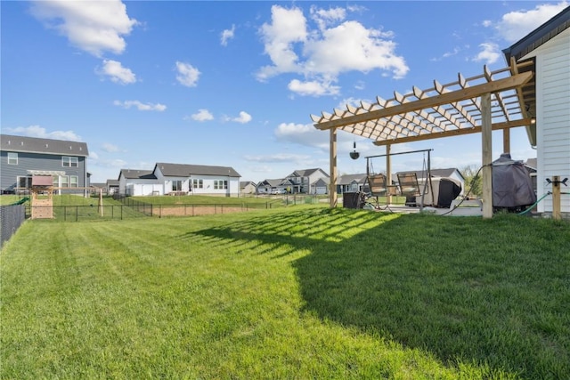 view of yard featuring a pergola, fence, and a residential view