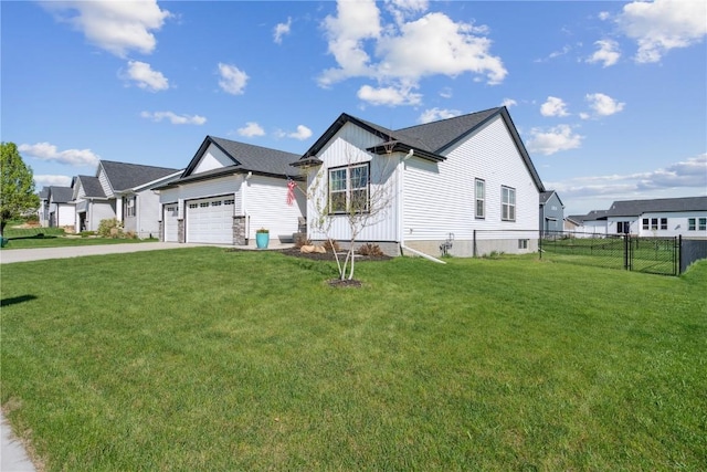 modern inspired farmhouse featuring board and batten siding, driveway, a front yard, fence, and an attached garage