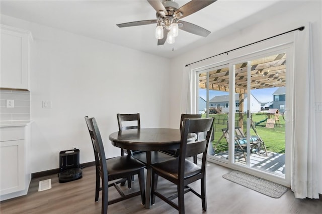dining area with baseboards, ceiling fan, and light wood-style flooring