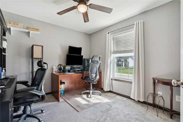 home office featuring carpet floors, baseboards, and a ceiling fan