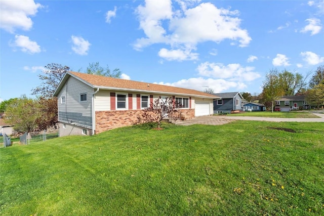 single story home with an attached garage, concrete driveway, a front yard, and brick siding