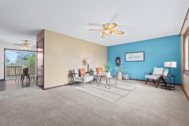 sitting room featuring baseboards, carpet flooring, and ceiling fan