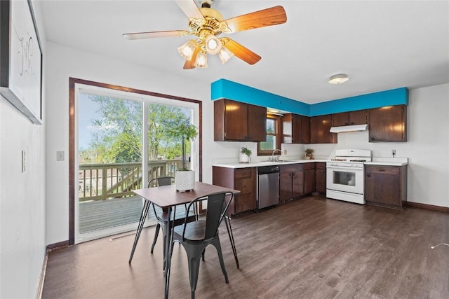 kitchen with stainless steel dishwasher, white gas range, light countertops, under cabinet range hood, and a sink