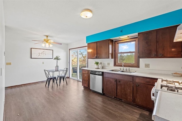 kitchen with a sink, dark wood-style flooring, dishwasher, and light countertops