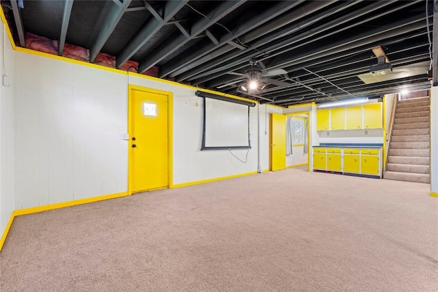 finished basement featuring stairs and carpet