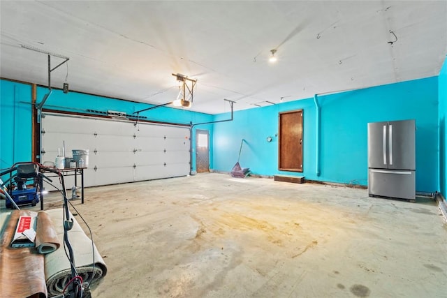 garage with a garage door opener and freestanding refrigerator