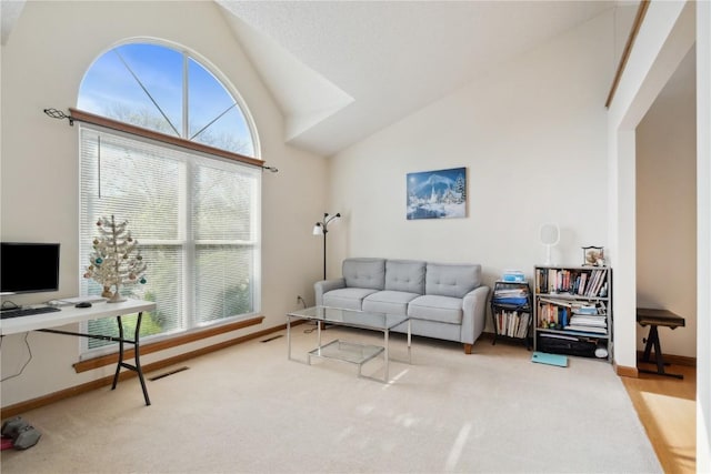 living area featuring high vaulted ceiling, baseboards, and carpet flooring