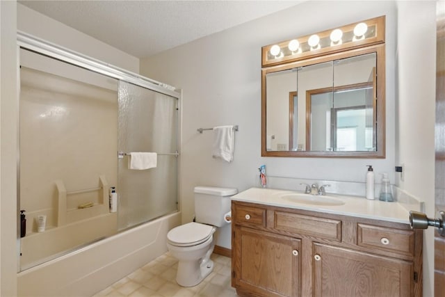 full bathroom with vanity, bath / shower combo with glass door, toilet, and a textured ceiling