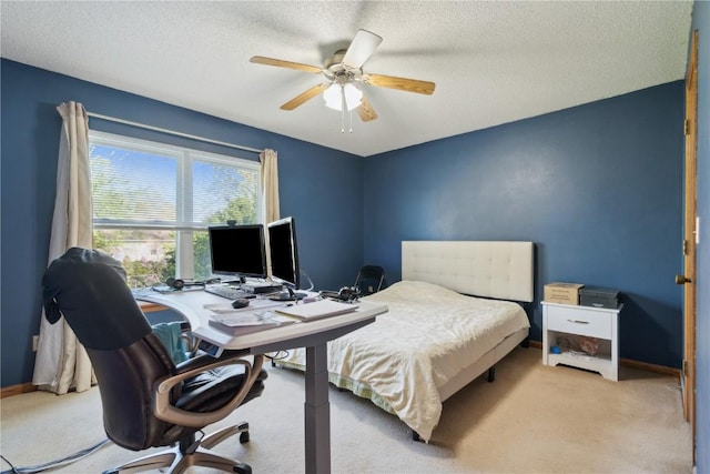 bedroom with baseboards, ceiling fan, carpet flooring, and a textured ceiling