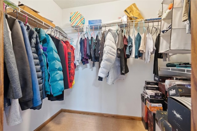 walk in closet with carpet floors