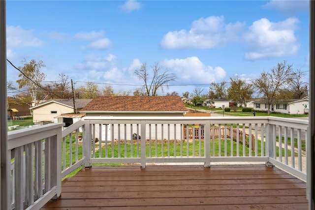 wooden deck featuring a yard and a residential view