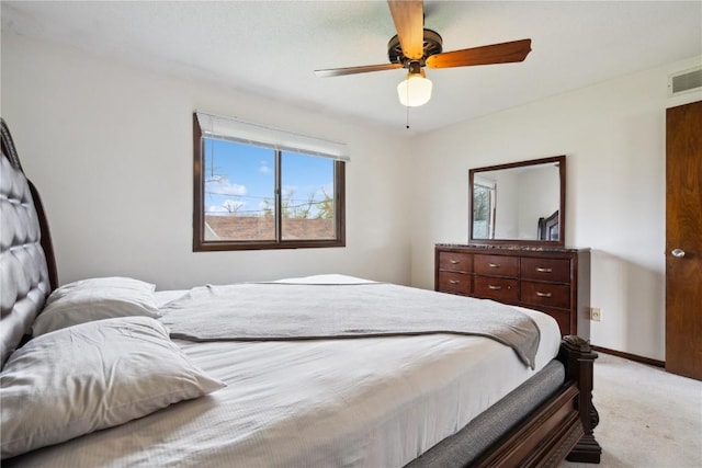 bedroom featuring a ceiling fan, baseboards, light colored carpet, and visible vents