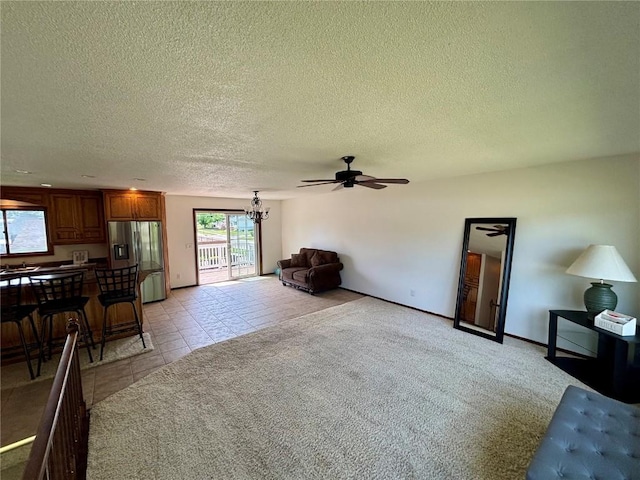 40 11th Ave, Hiawatha, IA 52233 - living area with a ceiling fan, a chandelier, a textured ceiling, and light tile patterned floors
