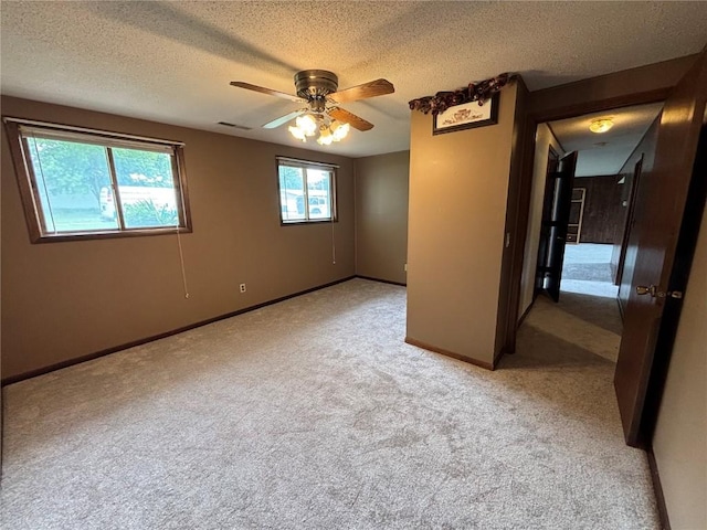40 11th Ave, Hiawatha, IA 52233 - spare room with light carpet, a textured ceiling, and a ceiling fan