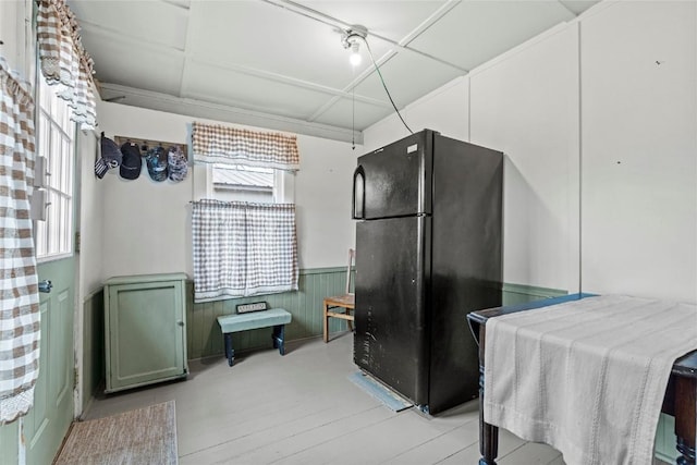kitchen with a wainscoted wall and freestanding refrigerator