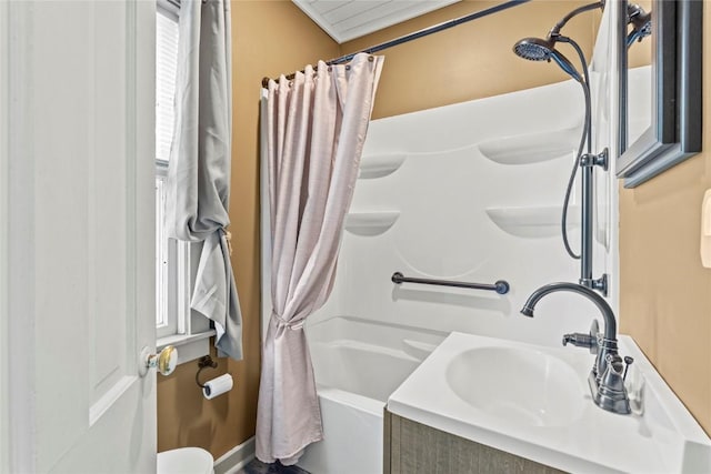 full bath featuring shower / bath combo with shower curtain and a sink