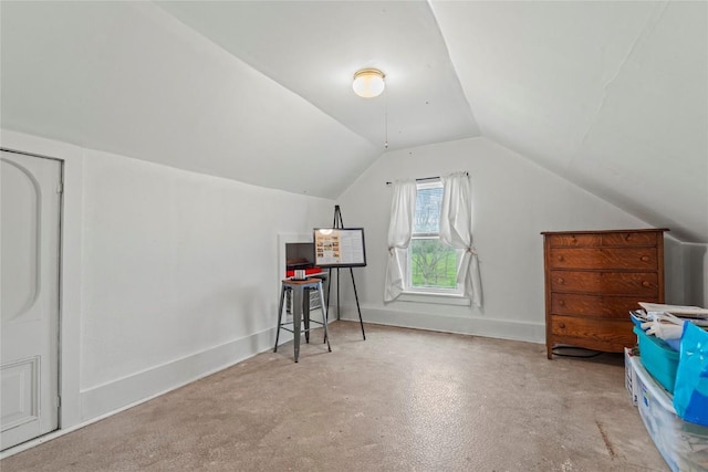 bonus room with concrete floors and lofted ceiling