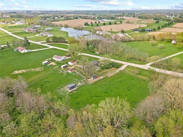 birds eye view of property featuring a water view and a rural view
