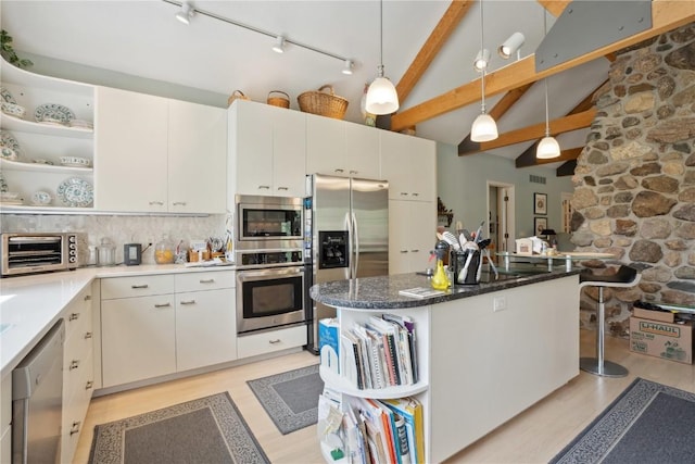 kitchen with a toaster, appliances with stainless steel finishes, open shelves, and light wood finished floors
