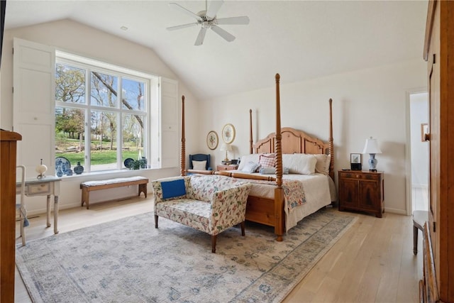 bedroom featuring light wood-style floors, a ceiling fan, and lofted ceiling