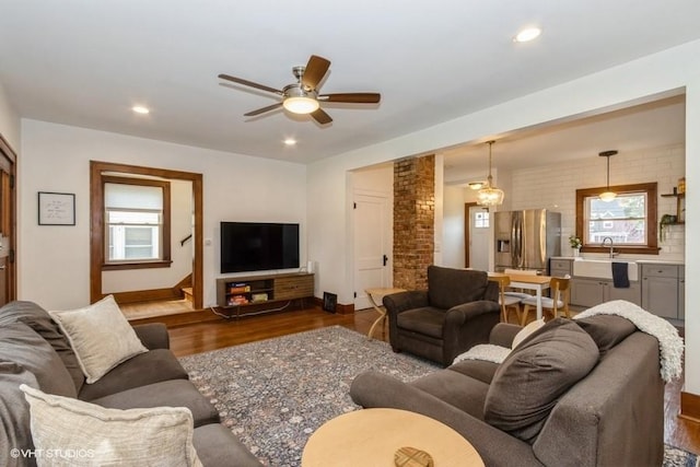 living room with dark wood-style flooring, a ceiling fan, recessed lighting, and plenty of natural light