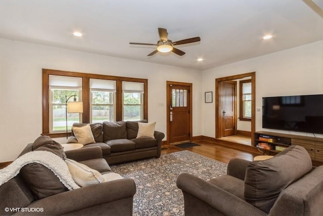 living area featuring a ceiling fan, baseboards, recessed lighting, and wood finished floors