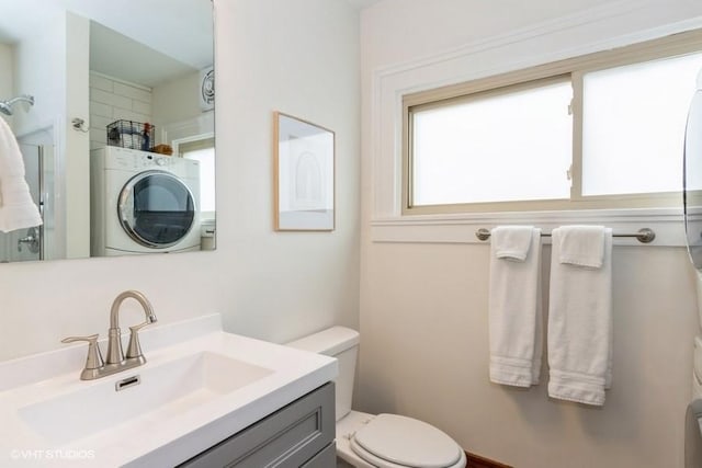 full bath with washer / clothes dryer, toilet, a shower, and vanity