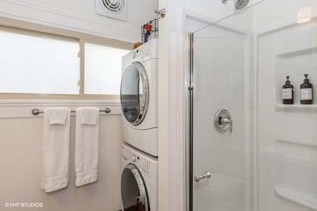 washroom featuring laundry area, stacked washer / drying machine, and visible vents