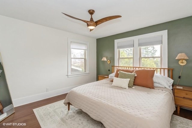 bedroom featuring baseboards, ceiling fan, and wood finished floors