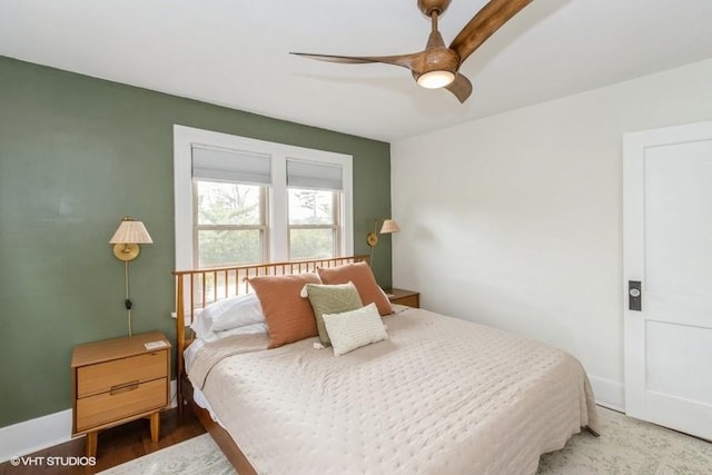 bedroom featuring baseboards, ceiling fan, and wood finished floors