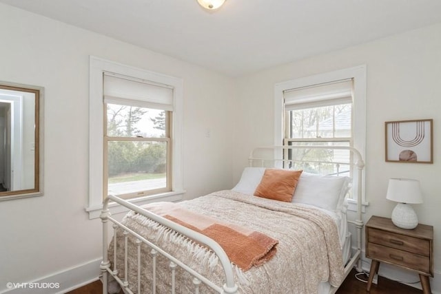 bedroom featuring baseboards and wood finished floors