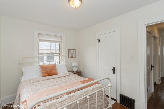 bedroom with visible vents and wood finished floors