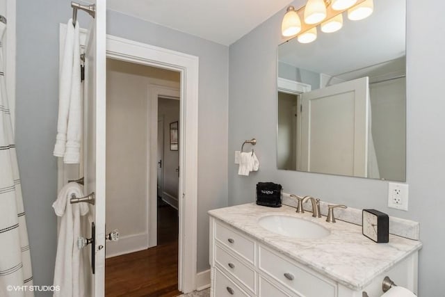 bathroom with wood finished floors and vanity