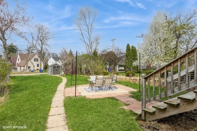 view of yard featuring a patio, an outbuilding, and a shed