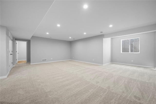 below grade area with light colored carpet, recessed lighting, and baseboards
