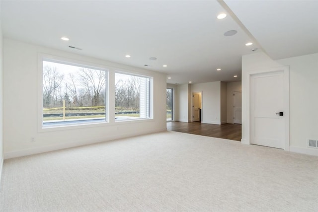 938 Heron Pl, Iowa City, IA 52245 - unfurnished living room with carpet floors, recessed lighting, baseboards, and visible vents
