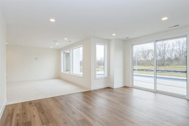 938 Heron Pl, Iowa City, IA 52245 - unfurnished living room with baseboards, recessed lighting, and wood finished floors