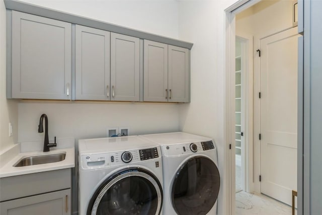 938 Heron Pl, Iowa City, IA 52245 - laundry room featuring a sink, marble finish floor, cabinet space, and washer and clothes dryer