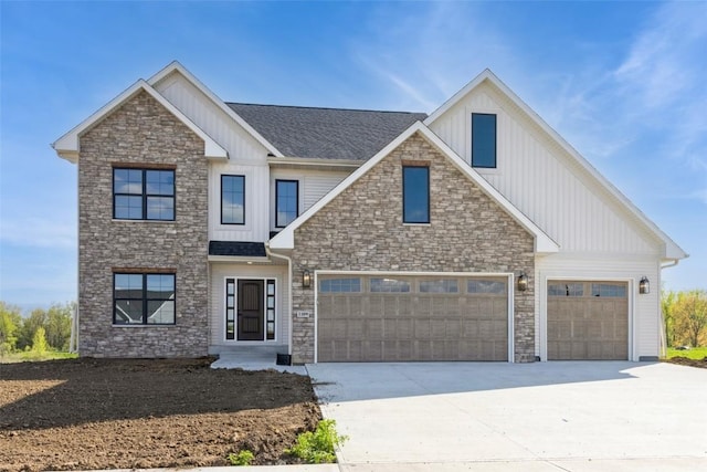 view of front of house featuring board and batten siding, concrete driveway, stone siding, and a shingled roof