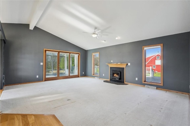 5141 25th Ave, Brandon, IA 52210 - unfurnished living room with ceiling fan, baseboards, beamed ceiling, a warm lit fireplace, and carpet