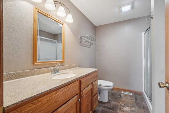 5141 25th Ave, Brandon, IA 52210 - full bathroom featuring vanity, toilet, stone finish flooring, visible vents, and a stall shower