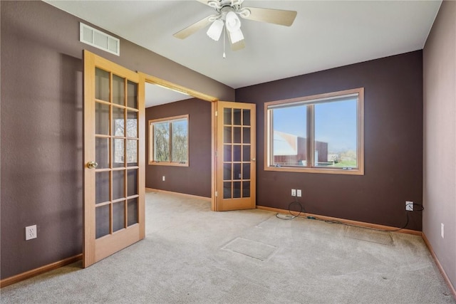 5141 25th Ave, Brandon, IA 52210 - carpeted spare room featuring visible vents, ceiling fan, a wealth of natural light, and french doors