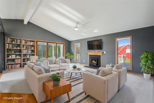 5141 25th Ave, Brandon, IA 52210 - living area featuring ceiling fan, a lit fireplace, beam ceiling, baseboards, and high vaulted ceiling