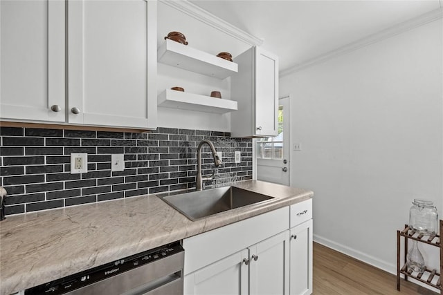 kitchen with a sink, open shelves, white cabinetry, and dishwasher