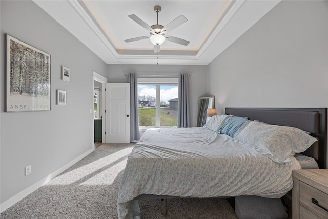 bedroom featuring baseboards, a ceiling fan, a raised ceiling, and carpet floors