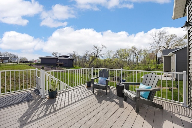 wooden terrace featuring a yard